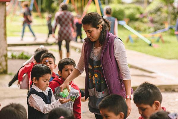 Woman giving water to child